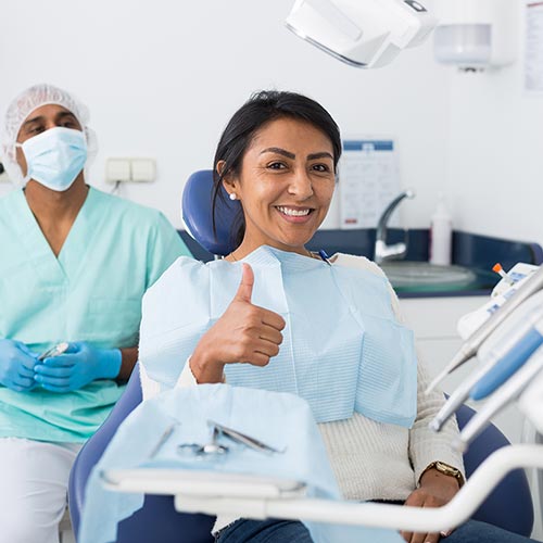 woman-giving-thumbs-up-in-dental-chair woman in dental chair