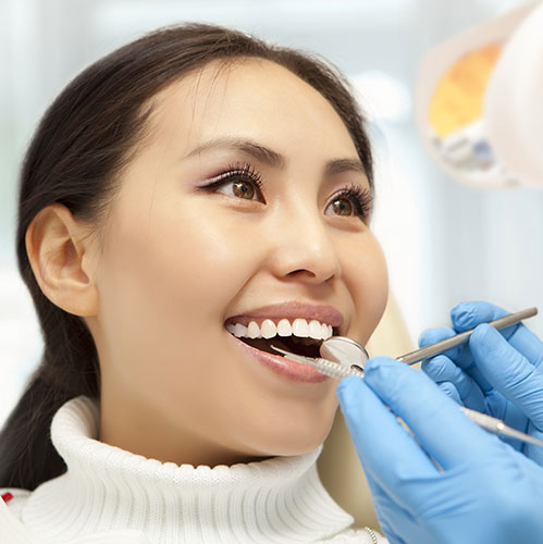 woman-smiling-at-dentist-teeth-cleaning man dentist